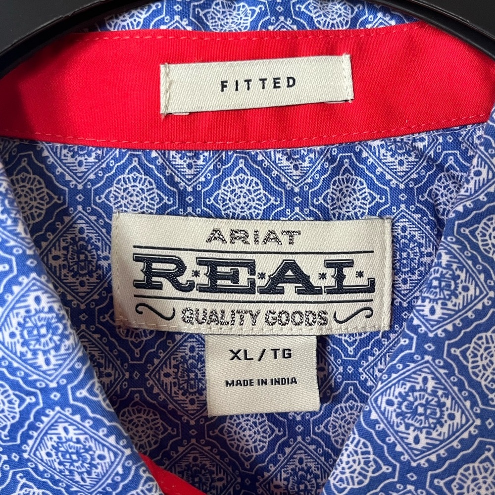Colorful, stretch material, orangish/red cuffs, detailed buttons on cuffs